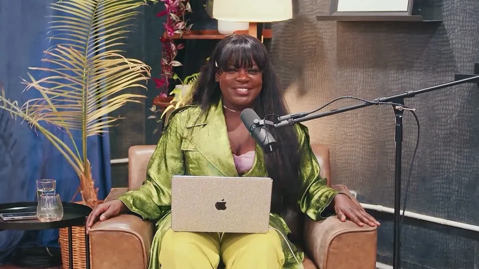 Dr. Raven Baxter in a green suit in The Science of Life studio